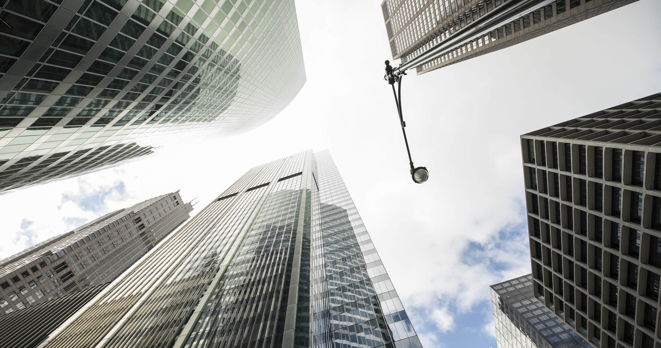 Looking up beside several skyscrapers