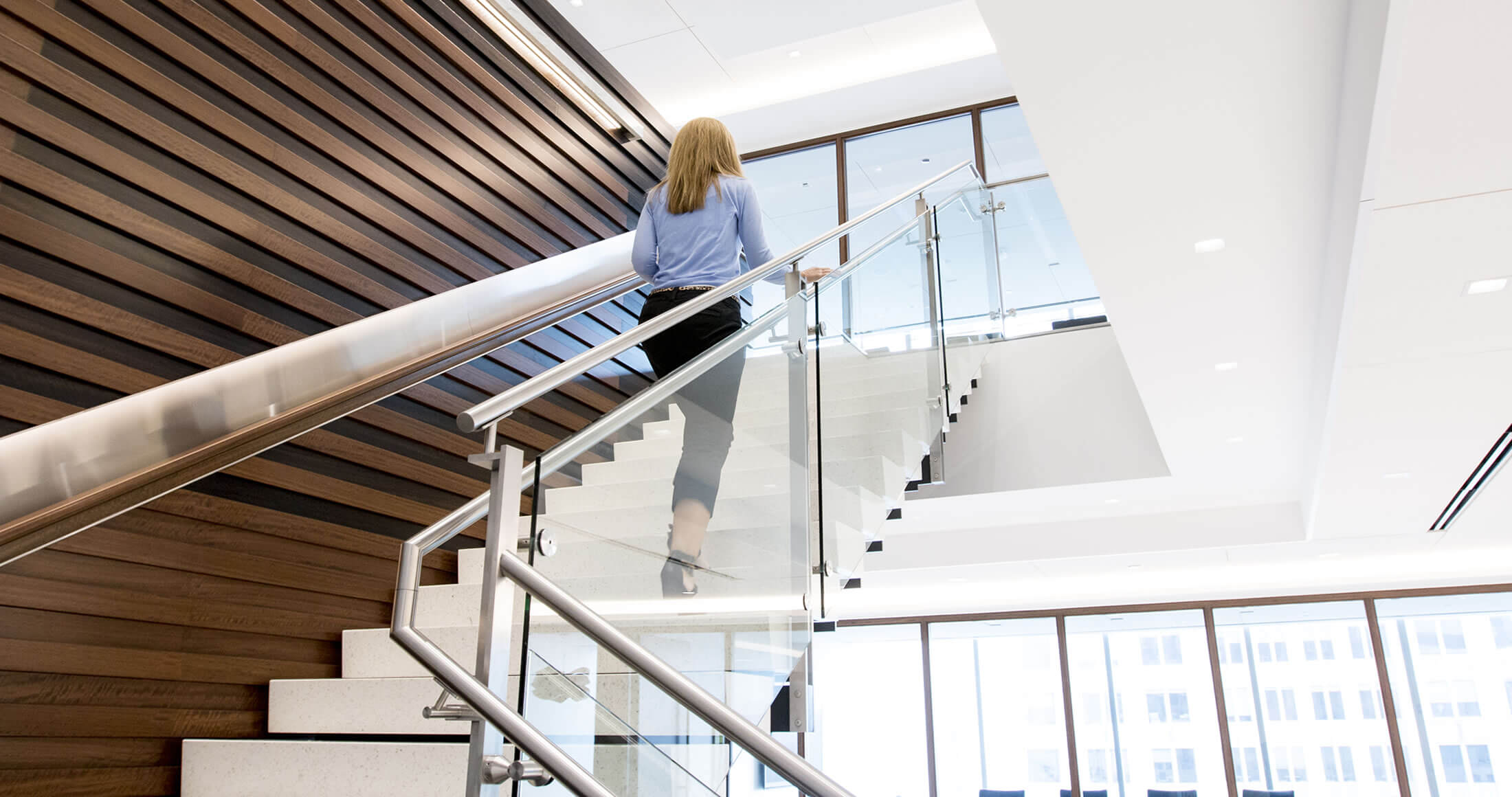 Woman walking up Harris Associates stairs